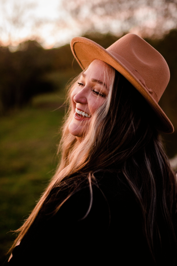 Side profile of woman smiling in sunset